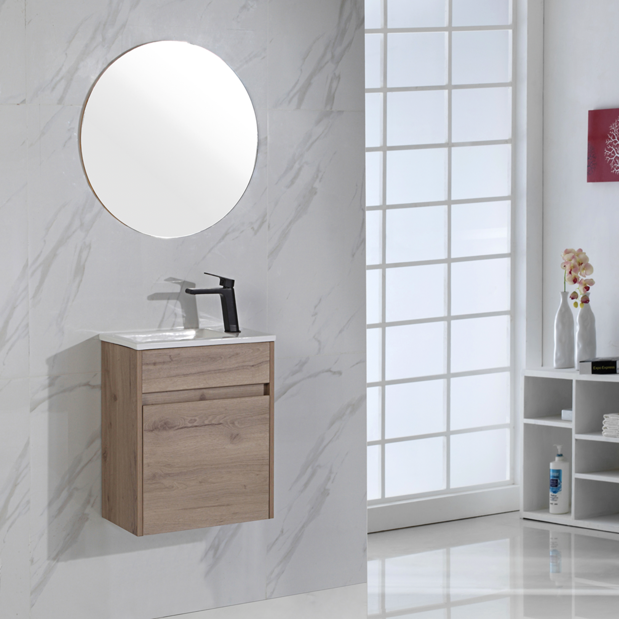 Bathroom with wooden vanity, round mirror, and marble wall.