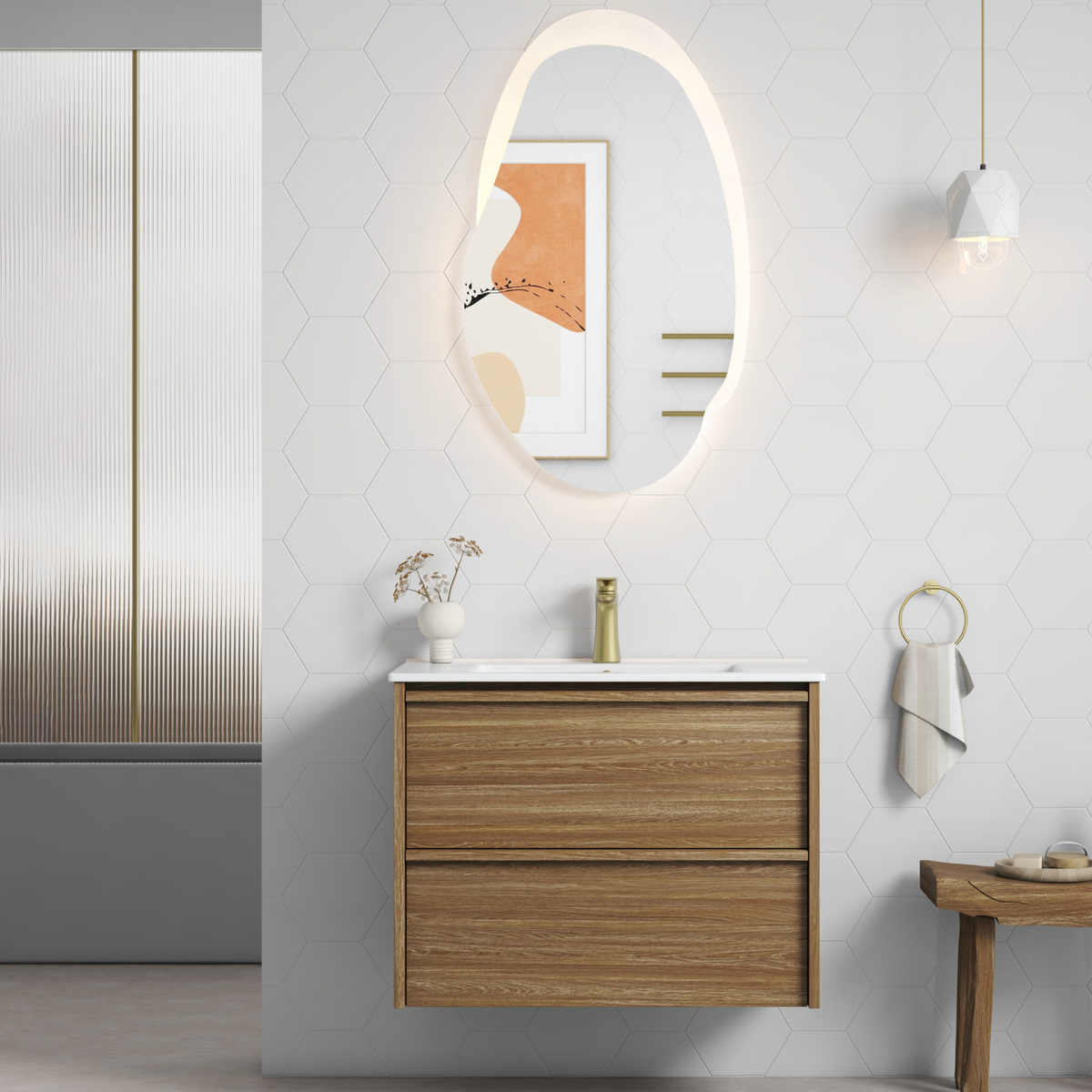 A modern bathroom vanity setup featuring a floating double-drawer cabinet in a warm wood finish, a white integrated ceramic basin countertop, a gold basin mixer tap.