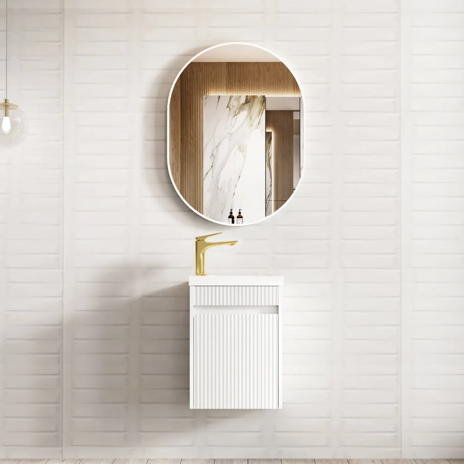 Bathroom wall hung vanity with round mirror and gold basin mixer tap against a white paneled wall.