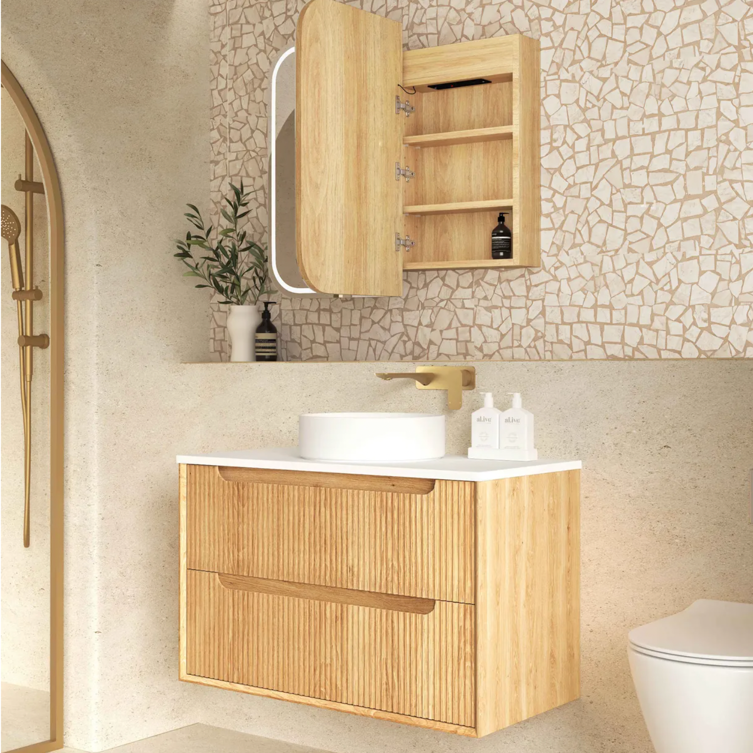 Bathroom with wooden vanity, mirror, and toilet against a tiled wall.