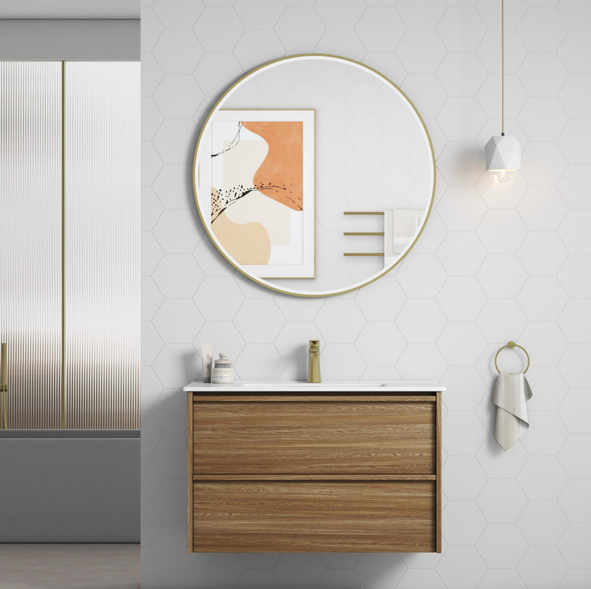 A modern floating bathroom vanity with a wood-grain finish and white countertop, paired with a large round gold-framed mirror on a white hexagonal-tiled wall.