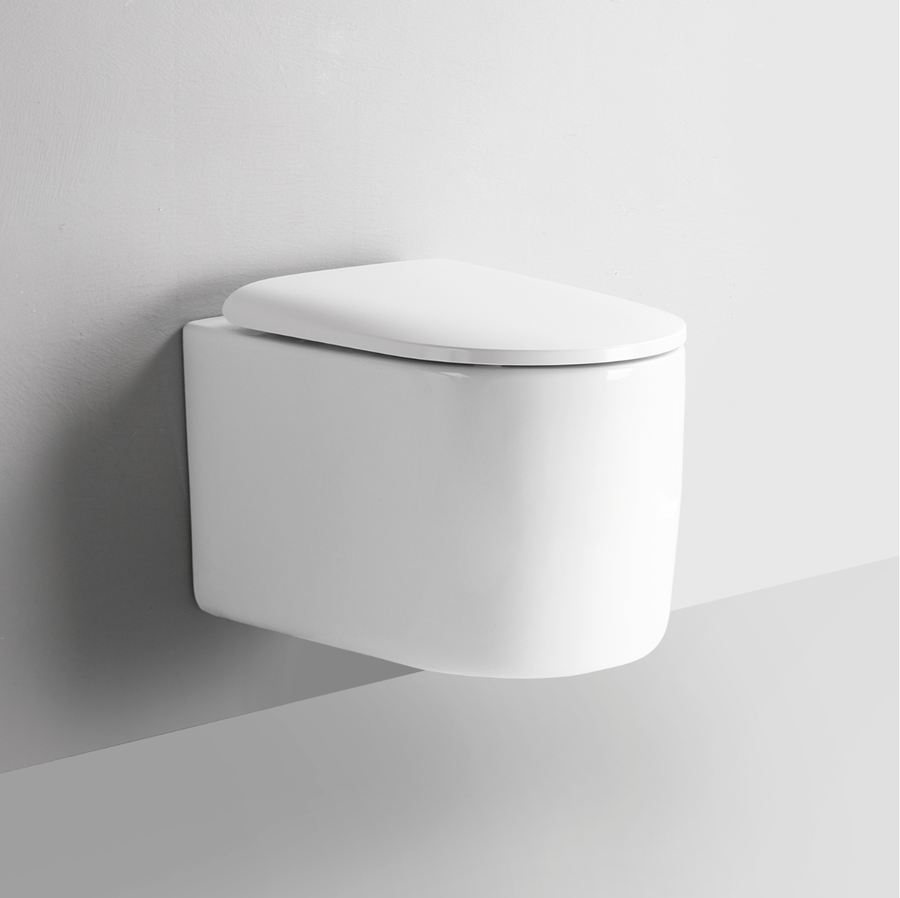 Wall-mounted white toilet against a plain background