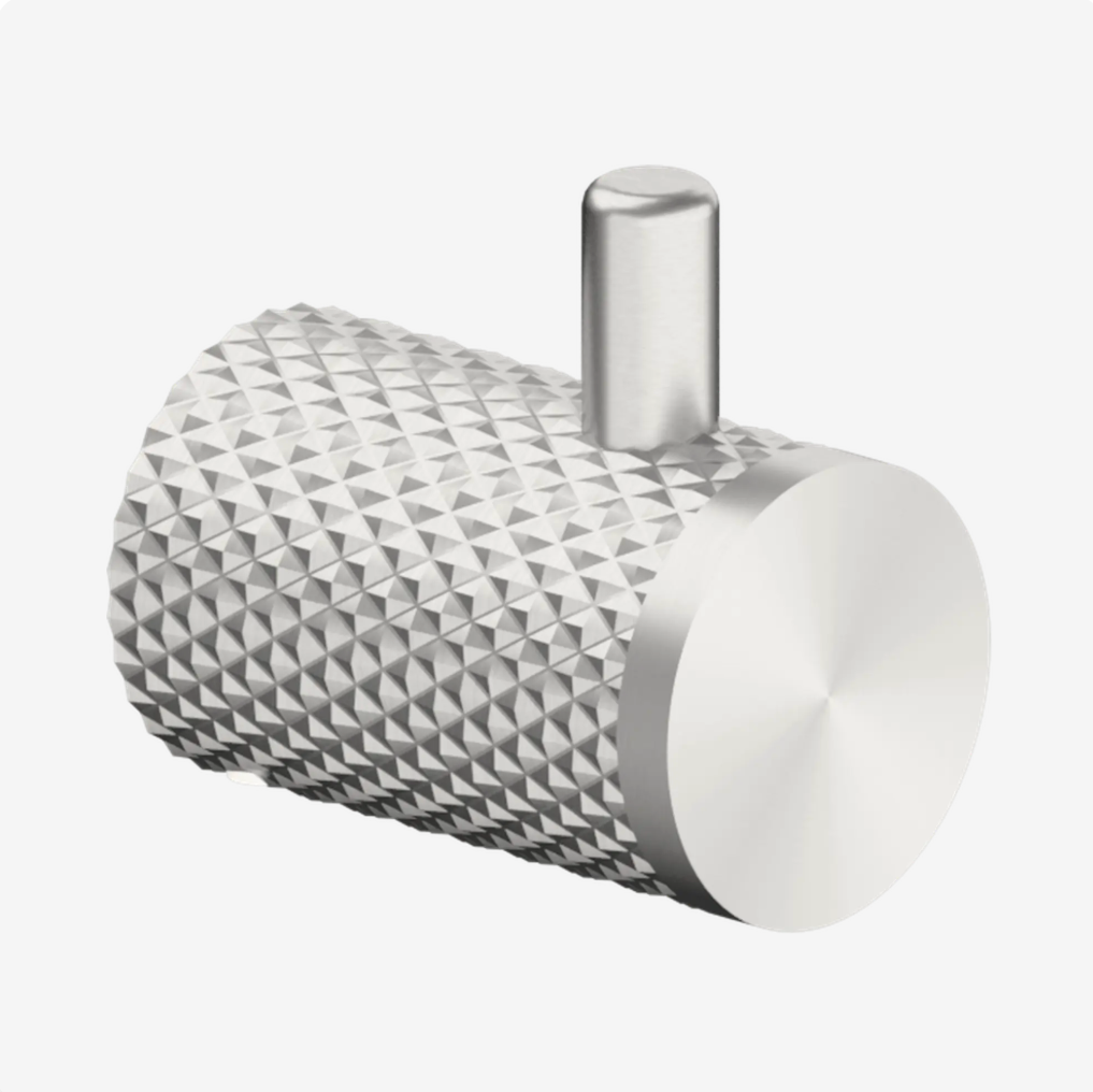 Brushed nickel-colored bathroom robe hook with textured surface 