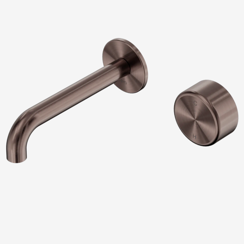 A modern wall-mounted bathroom mixer set with a curved spout and a separate round water control handle, both finished in a brushed bronze metal.