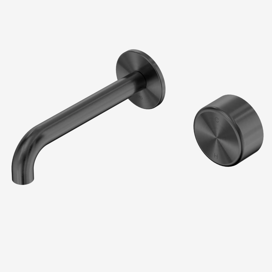 A gunmetal wall-mounted  spout and matching round progresive control water mixer knob.