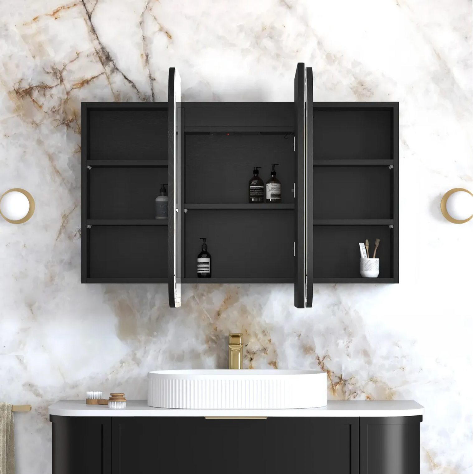Bathroom setup with black wall-mounted cabinet, white sink, and marble wall.