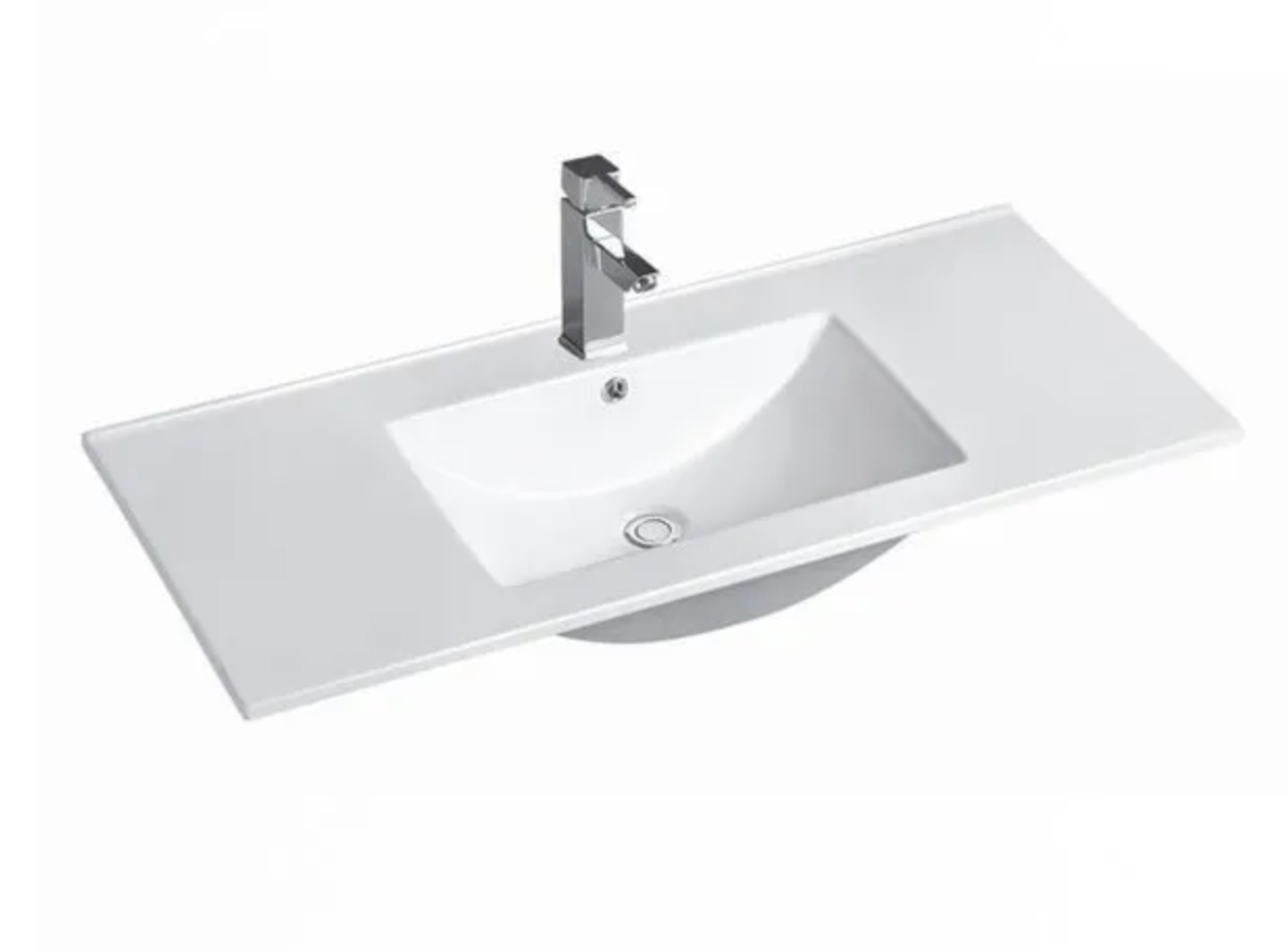 A glossy white ceramic vanity top with a single bowl and a metal faucet, against a white background.
